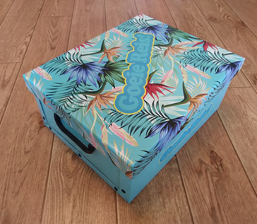 The box for the 'Good Trip!' toolkit. The blue box has a tropical print on the lid. The text 'Good trip!' is added diagonally over it.